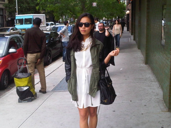Leah Ho, fashion blogger,  rocking a green/black leather jacket very in style